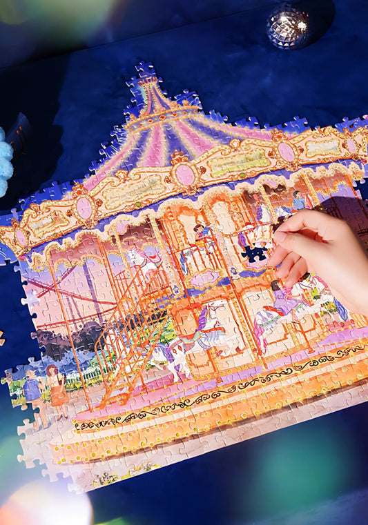 Hand placing a puzzle piece onto the nearly completed Starlit Carousel puzzle.