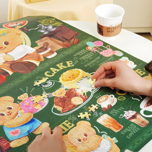 Close-up of hands assembling Butterbear – Bearista Delights puzzle, highlighting vibrant dessert illustrations.