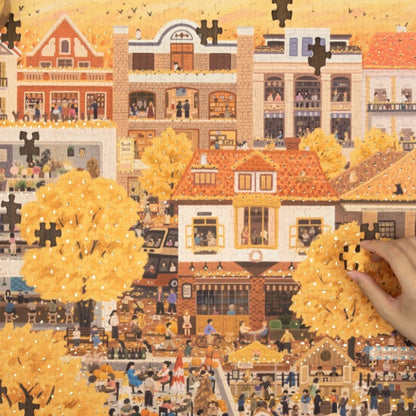 Partially completed puzzle highlighting foil details on autumn leaves.