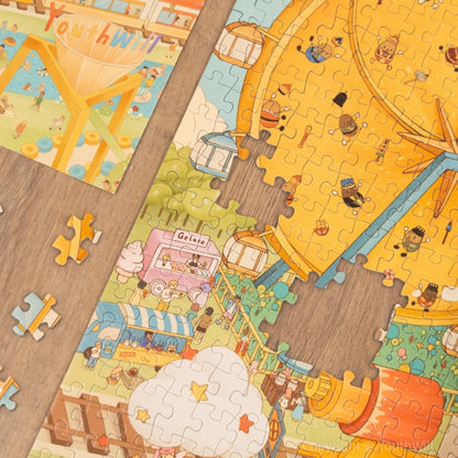 Puzzle detail showing coffee rides and biscuit Ferris wheel with product box.