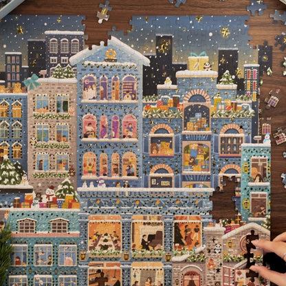 Jigsaw puzzle of a colorful cityscape with buildings and people on a wooden table.
