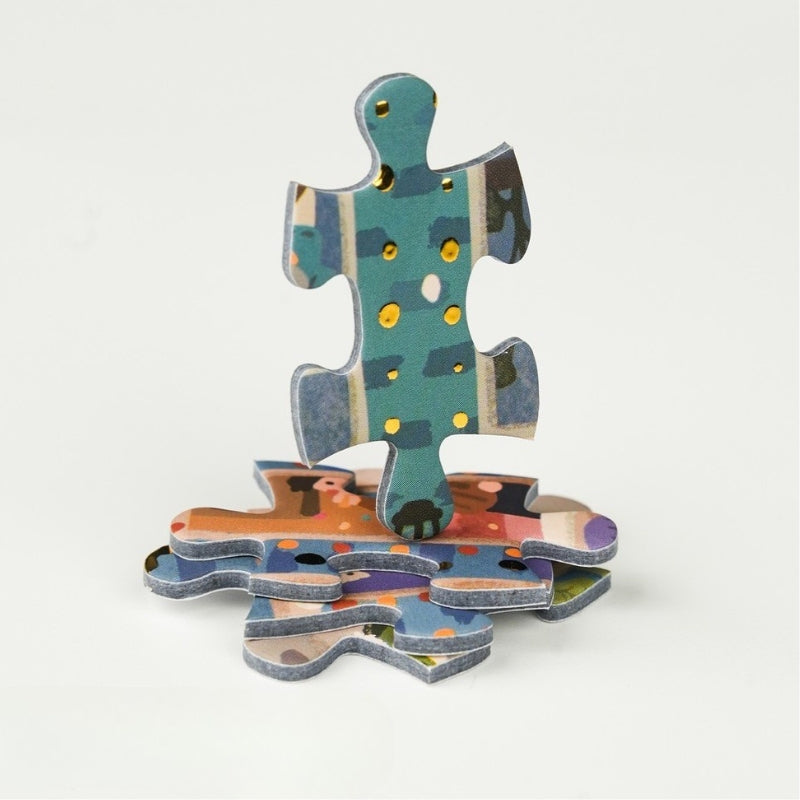 Stack of interlocking puzzle pieces with colourful foil details.