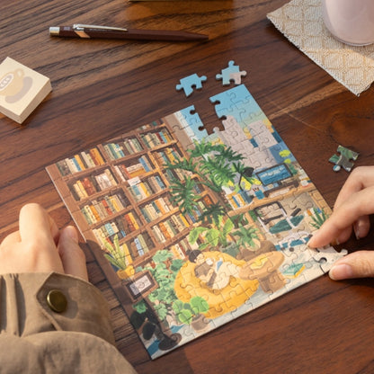 Partially assembled Snowy Cabin mini puzzle with pieces on a wooden table.