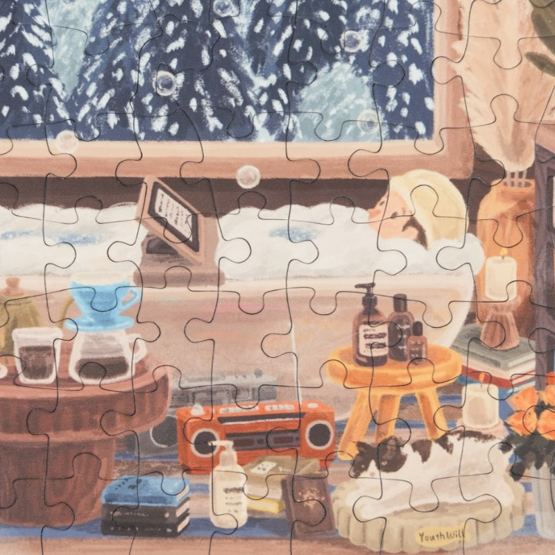Puzzle detail showing person in bathtub, books, and cosy cabin decor.