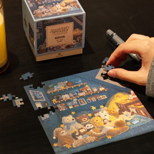 Flat lay showing Star Attic, Snowy Cabin, and Natural Room mini puzzles with boxes.
